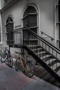 Old Bicycles Parked On Iron Stairs Beneath Building With Locked Massive Doors In The Inner City Of Vienna In Austria Royalty Free Stock Photo