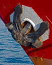 Old big anchor at red ship side Royalty Free Stock Photo