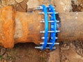 Old big drink water pipes joined with new blue valves and new blue joint members. Finished repaired piping waiting for covering by Royalty Free Stock Photo