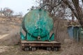 Old big old rusty automobile water tank with traces of rust. Abandoned waste rusty painted metal car tank, water barrel. Rusty Royalty Free Stock Photo