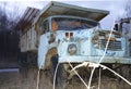 An old and big truck or car, with alot of rust