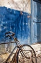 Old bike and blue door Royalty Free Stock Photo