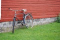 Old bike leaning against red wall Royalty Free Stock Photo