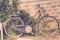 Old bike leans against an old brick wall, vintage Royalty Free Stock Photo