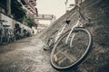 Old bike lying on stone wall