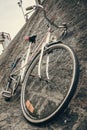 Old bike lying on stone wall