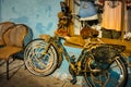 Old bike partially covered with natural sponges leaning on blue wall in Tarpon Springs Florida Royalty Free Stock Photo