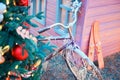 An old bike and skis stand near the wall of a wooden house. Preparing to celebrate the new year and christmas Royalty Free Stock Photo
