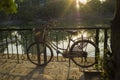 Old bike on urban pavement under afternoon bright sunlight