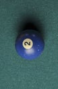Old billiard ball number 2 blue color on green billiard table, copy space