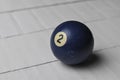 Old billiard ball number 2 blue color on white wooden table background, copy space Royalty Free Stock Photo