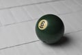 Old billiard ball number 6 green color on white wooden table background, copy space Royalty Free Stock Photo