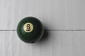 Old billiard ball number 6 green color on white wooden table background, copy space Royalty Free Stock Photo