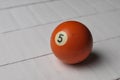 Old billiard ball number 5 orange color on white wooden table background, copy space Royalty Free Stock Photo