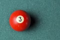 Old billiard ball number 3 red color on green billiard table, copy space Royalty Free Stock Photo