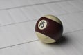 Old billiard ball number 15 striped white and brown on white wooden table background, copy space Royalty Free Stock Photo