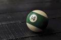 Old billiard ball number 14 striped white and green on black wooden table background, copy space Royalty Free Stock Photo