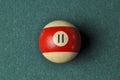 Old billiard ball number 11 striped white and red on green billiard table, copy space Royalty Free Stock Photo