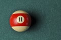 Old billiard ball number 11 striped white and red on green billiard table, copy space Royalty Free Stock Photo