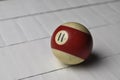 Old billiard ball number 11 striped white and red on white wooden table background, copy space Royalty Free Stock Photo