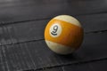 Old billiard ball number 9 striped white and yellow on black wooden table background, copy space Royalty Free Stock Photo