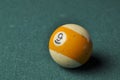 Old billiard ball number 9 striped white and yellow on green billiard table, copy space Royalty Free Stock Photo