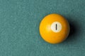 Old billiard ball number 1 yellow color on green billiard table, copy space Royalty Free Stock Photo