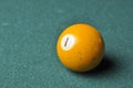 Old billiard ball number 1 yellow color on green billiard table, copy space Royalty Free Stock Photo