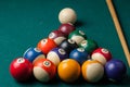 Old billiard balls and stick on a green table. billiard balls isolated on a green background Royalty Free Stock Photo