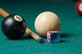 Old billiard ball 8 and stick on a green table. billiard balls isolated on a green background.Black and white