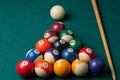 Old billiard balls and stick on a green table. billiard balls isolated on a green background Royalty Free Stock Photo