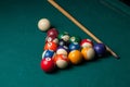 Old billiard balls and stick on a green table. billiard balls isolated on a green background Royalty Free Stock Photo