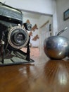 Old black camera and silver apple