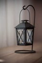 Old black candle lamp on the table