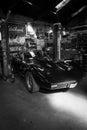 an black Corvette C3 stands in a workshop