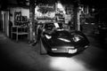 an black Corvette C3 stands in a workshop