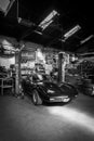 an black Corvette C3 stands in a workshop