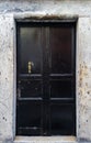 Old black door with bronze pull handle