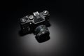 Old black film camera on black background. Royalty Free Stock Photo