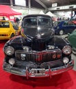 Old black 1948 Ford Mercury Eight coupe two door on the red carp