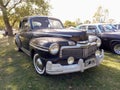 Old black 1948 Ford Mercury Eight V8 coupe in a park. Nature, grass, trees. Classic car show. Royalty Free Stock Photo