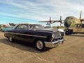 Old black 1953 Ford Mercury Monterey coupe hardtop at an airstrip. Classic car show. Royalty Free Stock Photo