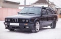 Old, black, German family car front view in winter