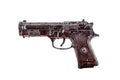 Old black gun in red blood isolated on white background Royalty Free Stock Photo