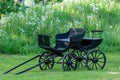 Old black horse carriage with wooden wheels Royalty Free Stock Photo