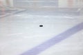 Old black Ice Hockey puck on ice arena hockey rink Royalty Free Stock Photo