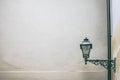 Old black iron vintage lamp, lantern on building wall Royalty Free Stock Photo