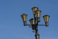 Old black lantern on the background with blue sky