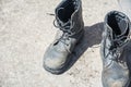 Old Black Leather army boots. Military boots of soldiers standing on the cement ground Royalty Free Stock Photo