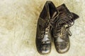 Old black leather shoes on the floor. Pair of old dirty black leather shoes Royalty Free Stock Photo